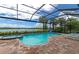 Inviting freeform pool with spa and screened enclosure at 6358 Rivo Lakes Blvd, Sarasota, FL 34241