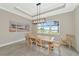 Bright dining room with large windows overlooking a lake at 6358 Rivo Lakes Blvd, Sarasota, FL 34241