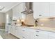 Bright kitchen with white cabinets, granite countertops, and a farmhouse sink at 6358 Rivo Lakes Blvd, Sarasota, FL 34241