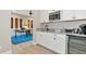 Modern wet bar with granite countertop and mini-fridge at 6358 Rivo Lakes Blvd, Sarasota, FL 34241