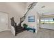 Elegant staircase with dark wood railings and a modern design at 6358 Rivo Lakes Blvd, Sarasota, FL 34241