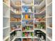 Well-organized pantry with ample shelving for food storage at 6358 Rivo Lakes Blvd, Sarasota, FL 34241