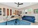 Home office with a large desk, comfortable sofa, and plenty of natural light at 6358 Rivo Lakes Blvd, Sarasota, FL 34241