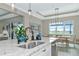 Spacious kitchen with white cabinets, breakfast bar, and kitchen sink at 6358 Rivo Lakes Blvd, Sarasota, FL 34241