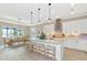 Modern kitchen with white cabinetry, large island, and breakfast nook at 6358 Rivo Lakes Blvd, Sarasota, FL 34241