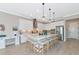 Elegant kitchen featuring white cabinets, stainless steel appliances, and an island at 6358 Rivo Lakes Blvd, Sarasota, FL 34241