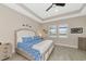 Spacious bedroom with a king-size bed and large windows at 6358 Rivo Lakes Blvd, Sarasota, FL 34241