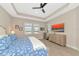 Spacious bedroom with a king-size bed and large windows at 6358 Rivo Lakes Blvd, Sarasota, FL 34241