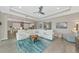 Spacious living room features a large sectional sofa and open concept to the kitchen at 6358 Rivo Lakes Blvd, Sarasota, FL 34241