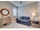 A cozy bedroom with a blue loveseat, light wood furniture and carpeted floors at 8930 Tuscany Isles Dr, Punta Gorda, FL 33950