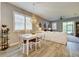 Bright dining area features a chandelier, wood floors and view into adjacent living room at 8930 Tuscany Isles Dr, Punta Gorda, FL 33950