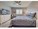 King bedroom with gray chair, white dresser, and window with plantation shutters at 8930 Tuscany Isles Dr, Punta Gorda, FL 33950