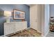 Stylish entryway with blue accent wall, white console table, decorative lamp, and front door at 8930 Tuscany Isles Dr, Punta Gorda, FL 33950