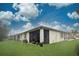 Exterior view of the home highlighting the screened lanai and landscaped yard at 8930 Tuscany Isles Dr, Punta Gorda, FL 33950