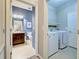 Hallway between laundry room and bathroom with views of the vanity and washer/dryer at 8930 Tuscany Isles Dr, Punta Gorda, FL 33950