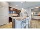 Open-concept kitchen boasts granite counters, dark wood cabinetry, and breakfast bar with seating at 8930 Tuscany Isles Dr, Punta Gorda, FL 33950