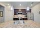 Gourmet kitchen features island with sink, updated stainless appliances, and stylish pendant lights at 8930 Tuscany Isles Dr, Punta Gorda, FL 33950