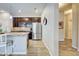 Kitchen with wood cabinets, stainless steel refrigerator, and breakfast bar at 8930 Tuscany Isles Dr, Punta Gorda, FL 33950