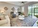 Cozy living room featuring comfortable seating, decorative wall art, and access to the lanai at 8930 Tuscany Isles Dr, Punta Gorda, FL 33950