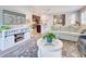 Inviting living room with comfortable seating, rug, and open access to kitchen and dining at 8930 Tuscany Isles Dr, Punta Gorda, FL 33950