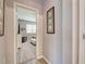 Bright hallway with light gray walls and wood-look flooring, leading to a bedroom at 8930 Tuscany Isles Dr, Punta Gorda, FL 33950