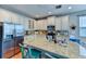 Island kitchen with granite countertops, stainless steel appliances, and white cabinets at 4247 Adelaar Dr, Sarasota, FL 34240