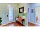 Bright entryway with hardwood floors and charming decor at 4247 Adelaar Dr, Sarasota, FL 34240