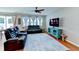 Living room with leather reclining sofas and ceiling fan at 4247 Adelaar Dr, Sarasota, FL 34240