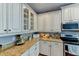 Kitchen features white cabinets, granite countertops and stainless steel appliances at 4247 Adelaar Dr, Sarasota, FL 34240