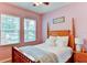 Charming bedroom with a wooden bed frame and soft color palette at 4247 Adelaar Dr, Sarasota, FL 34240
