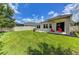 Spacious backyard with covered patio, lush lawn, and privacy fence at 4247 Adelaar Dr, Sarasota, FL 34240