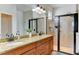 Bathroom with double sinks, granite countertop, and large walk-in shower at 4247 Adelaar Dr, Sarasota, FL 34240