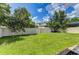 Large grassy backyard with a white privacy fence at 4247 Adelaar Dr, Sarasota, FL 34240