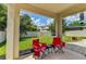 Covered patio with backyard access and firepit at 4247 Adelaar Dr, Sarasota, FL 34240