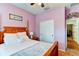Second bedroom with a wooden bed frame and access to a hallway at 4247 Adelaar Dr, Sarasota, FL 34240