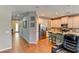 Hardwood floor hallway with view into kitchen and entryway at 4247 Adelaar Dr, Sarasota, FL 34240