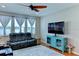 Relaxing living room featuring leather recliners and ceiling fan at 4247 Adelaar Dr, Sarasota, FL 34240