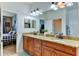 Double vanity bathroom with granite countertop and large mirror at 4247 Adelaar Dr, Sarasota, FL 34240