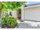 House exterior featuring a white facade, landscaped front yard, and a white garage door at 4247 Adelaar Dr, Sarasota, FL 34240