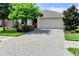 Single-Gathering home with a paved driveway and landscaping at 4247 Adelaar Dr, Sarasota, FL 34240