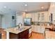 Kitchen features white cabinets, granite countertops and stainless steel appliances at 4247 Adelaar Dr, Sarasota, FL 34240