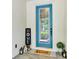 Close-up of the teal front door, featuring glass inserts and a welcoming mat at 4247 Adelaar Dr, Sarasota, FL 34240