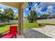 Relaxing backyard patio with lawn and partial view of other homes at 4247 Adelaar Dr, Sarasota, FL 34240