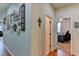Home hallway with decorative wall and views into office and other rooms at 4247 Adelaar Dr, Sarasota, FL 34240