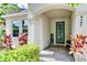 Welcoming front door with a blue finish and glass panels, accented by potted plants at 4247 Adelaar Dr, Sarasota, FL 34240