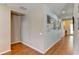 Bright hallway with wood flooring and decorative wall at 4247 Adelaar Dr, Sarasota, FL 34240