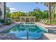 Community pool with lounge chairs and a pergola at 7324 Gulf Dr # 12, Holmes Beach, FL 34217