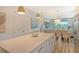 Open concept kitchen with island, white cabinets, and view into living area at 10434 Spring Tide Way, Parrish, FL 34219