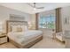 Spacious main bedroom with a plush bed and large window overlooking a golf course at 10434 Spring Tide Way, Parrish, FL 34219
