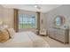 Main bedroom featuring a comfortable bed, dresser, and access to the bathroom at 10434 Spring Tide Way, Parrish, FL 34219